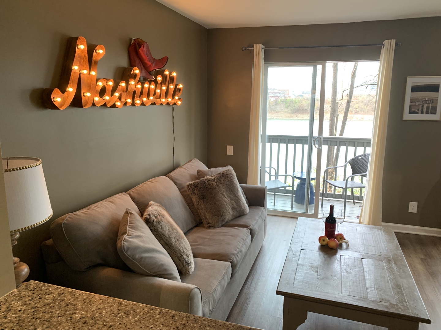 Living room with sofa sleeper, Smart TV, and balcony