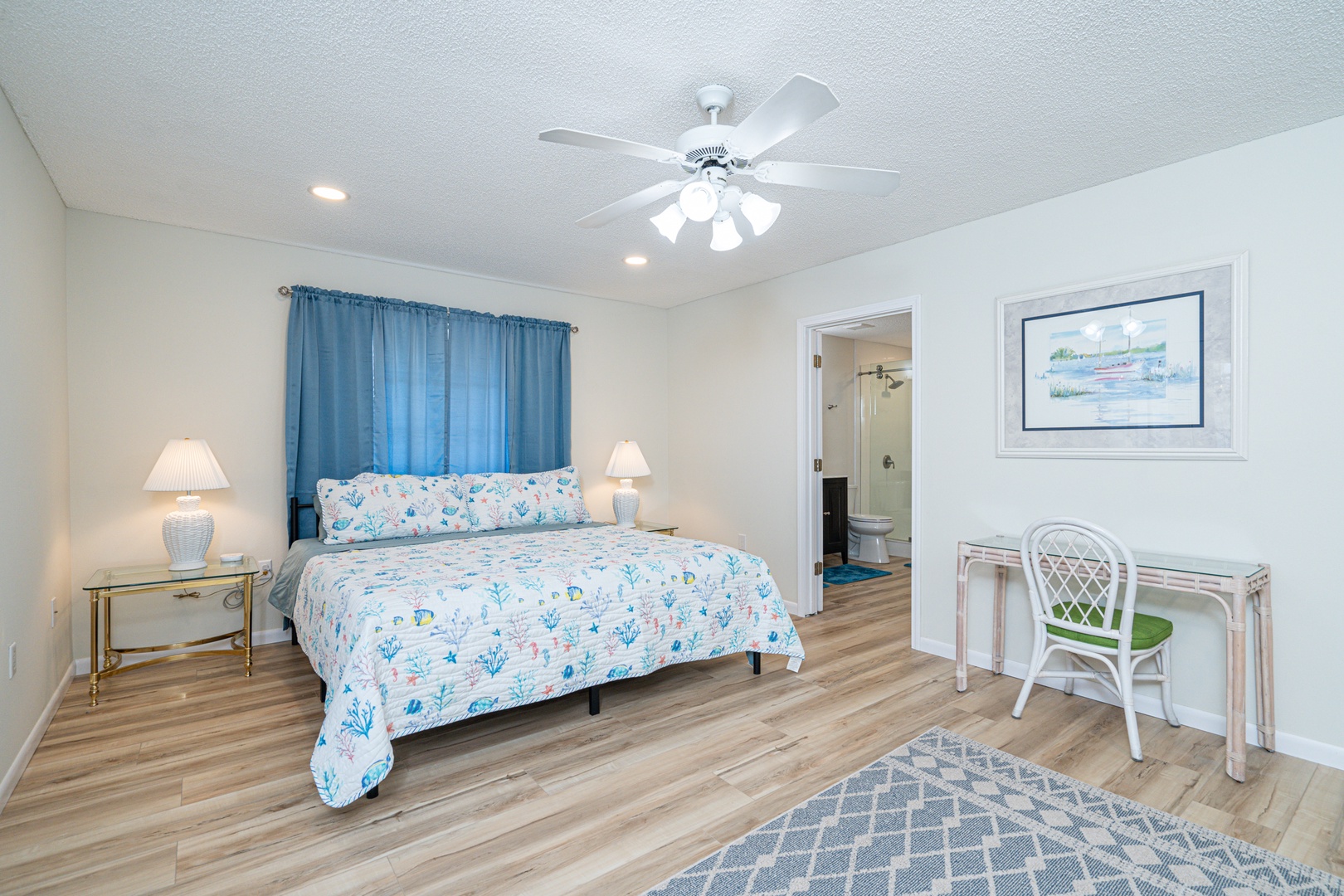 This coastal king suite boasts a private ensuite, smart TV, & patio access