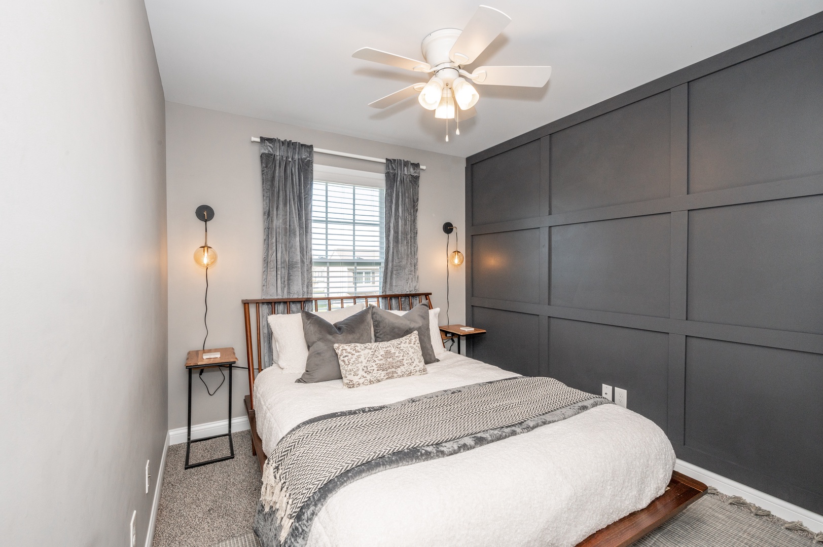 This main-level bedroom includes a queen bed & ceiling fan