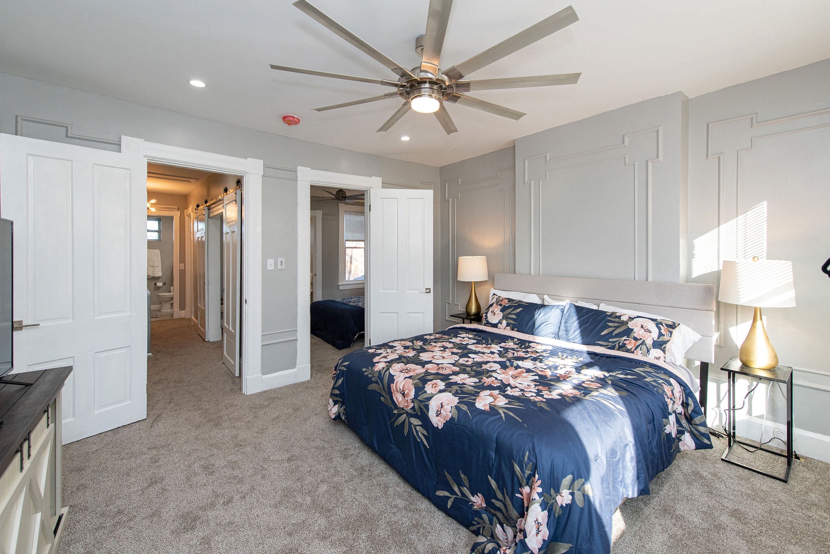 Suite 2 – The primary bedroom offers a king bed, Smart TV, & ceiling fan