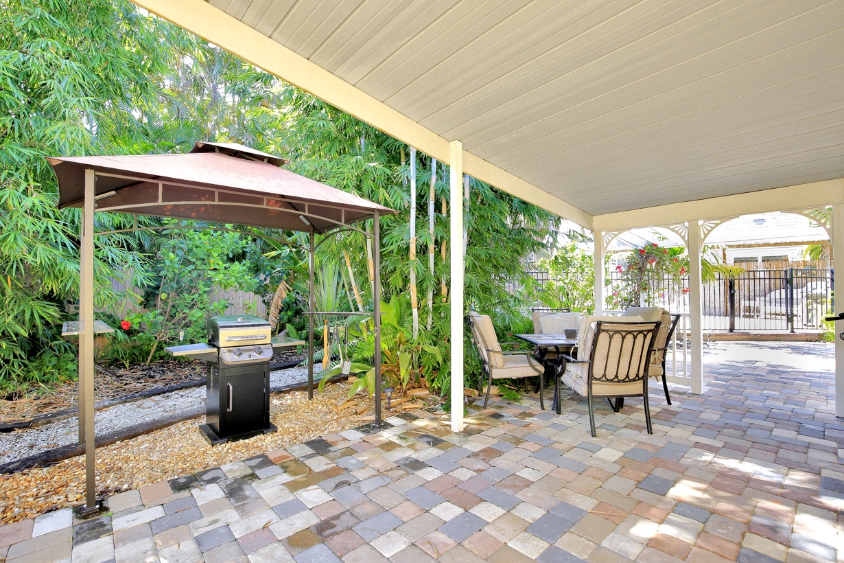 Tropical patio with outdoor seating and BBQ