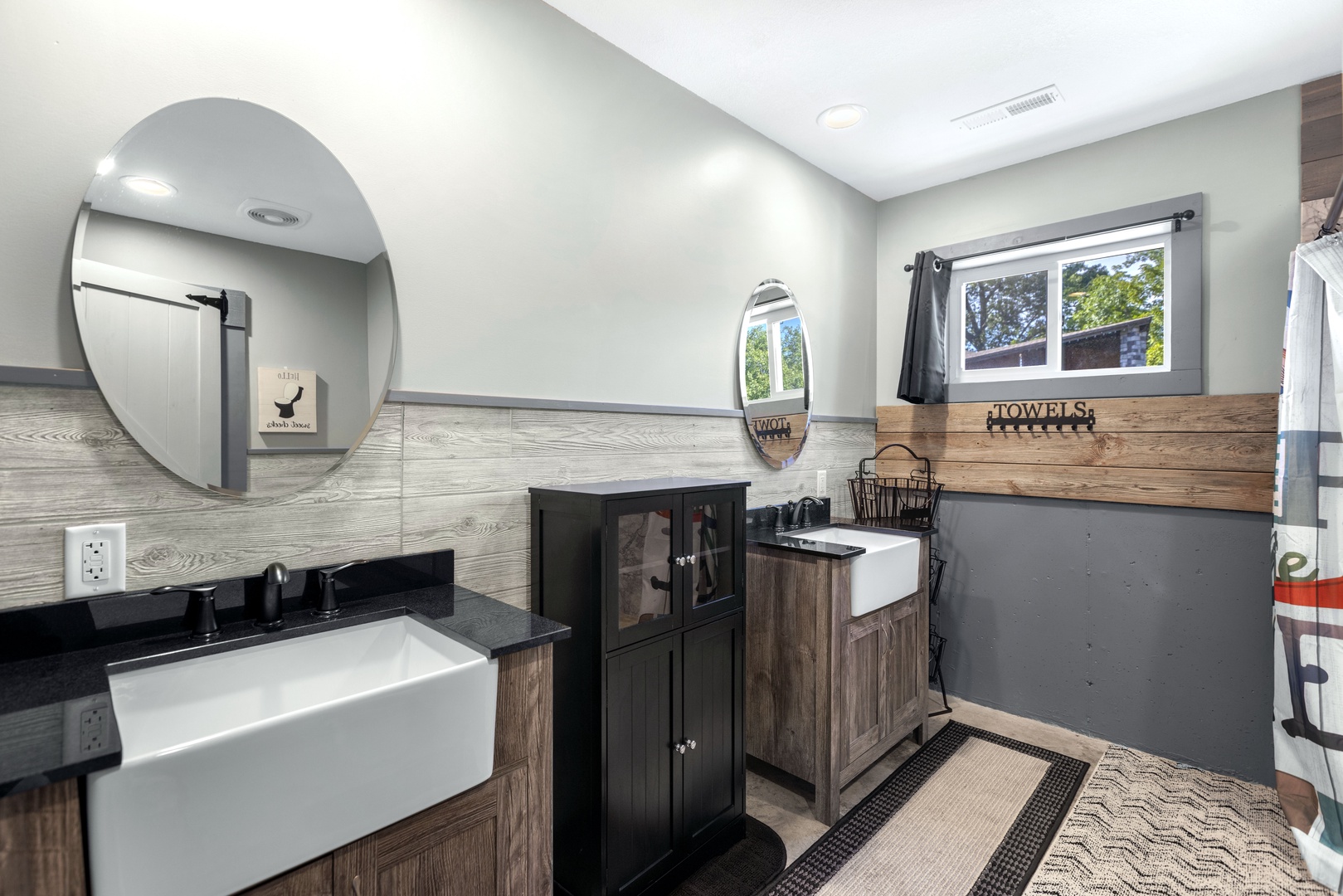 Full bathroom with dual sinks and stand up shower