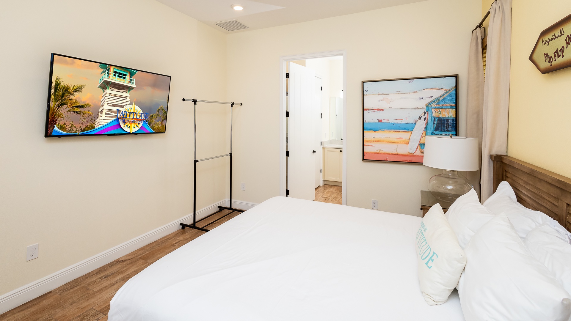 This beachy main-floor king suite boasts a private ensuite, Smart TV, & patio access