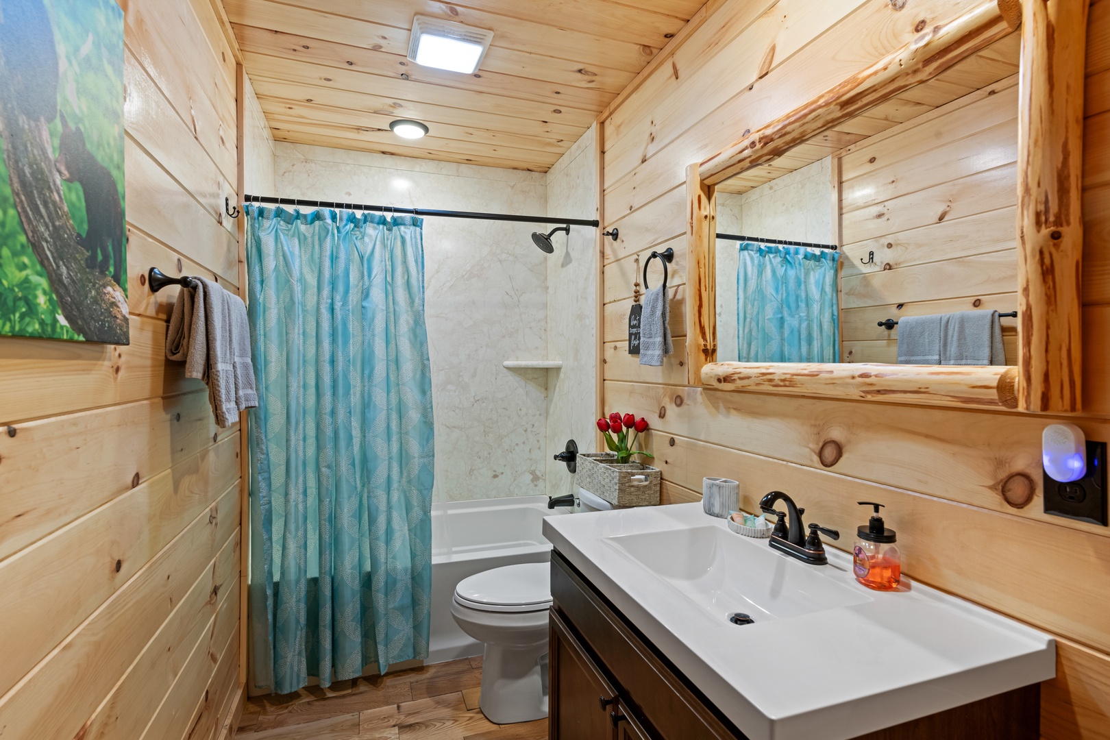 A single vanity & shower/tub combo await in the second ensuite bath