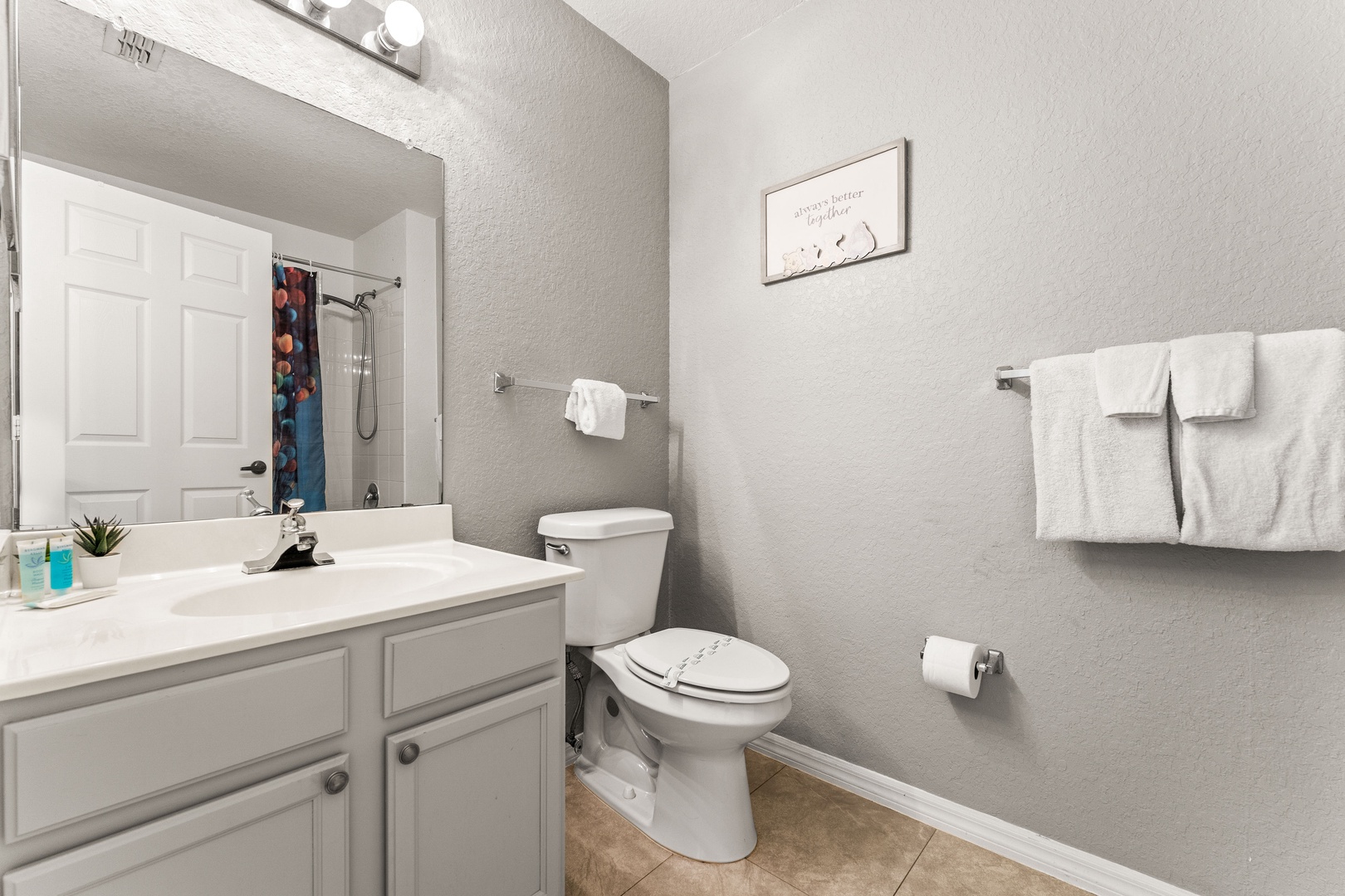Shared bathroom w/ shower/tub combo & an additional separate vanity area