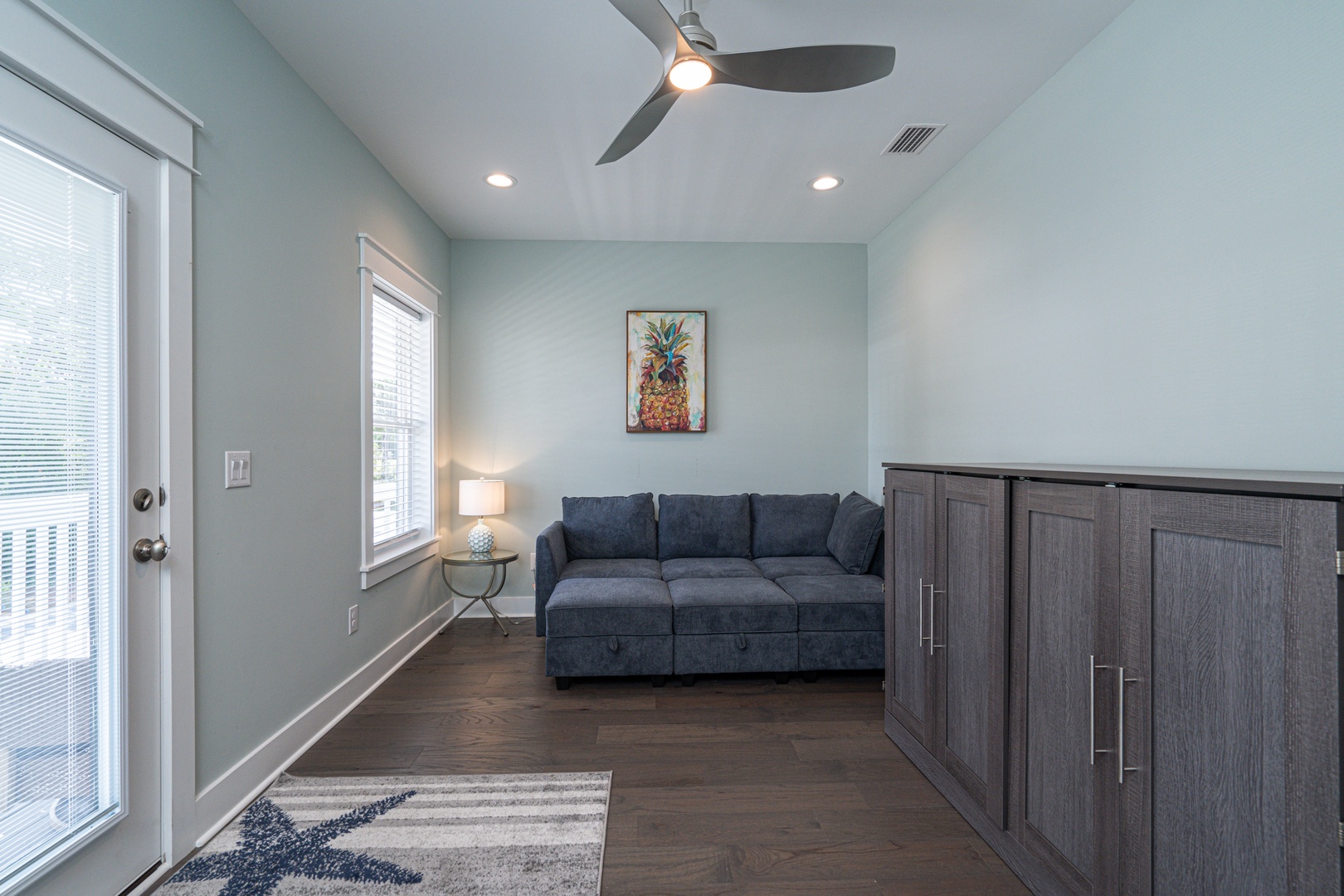 Sun room with queen murphy bed, balcony, seating and TV