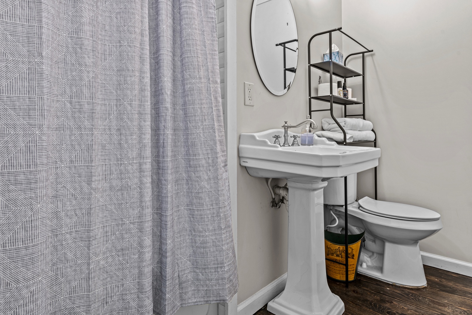 This full bathroom offers a pedestal sink & shower/tub combo