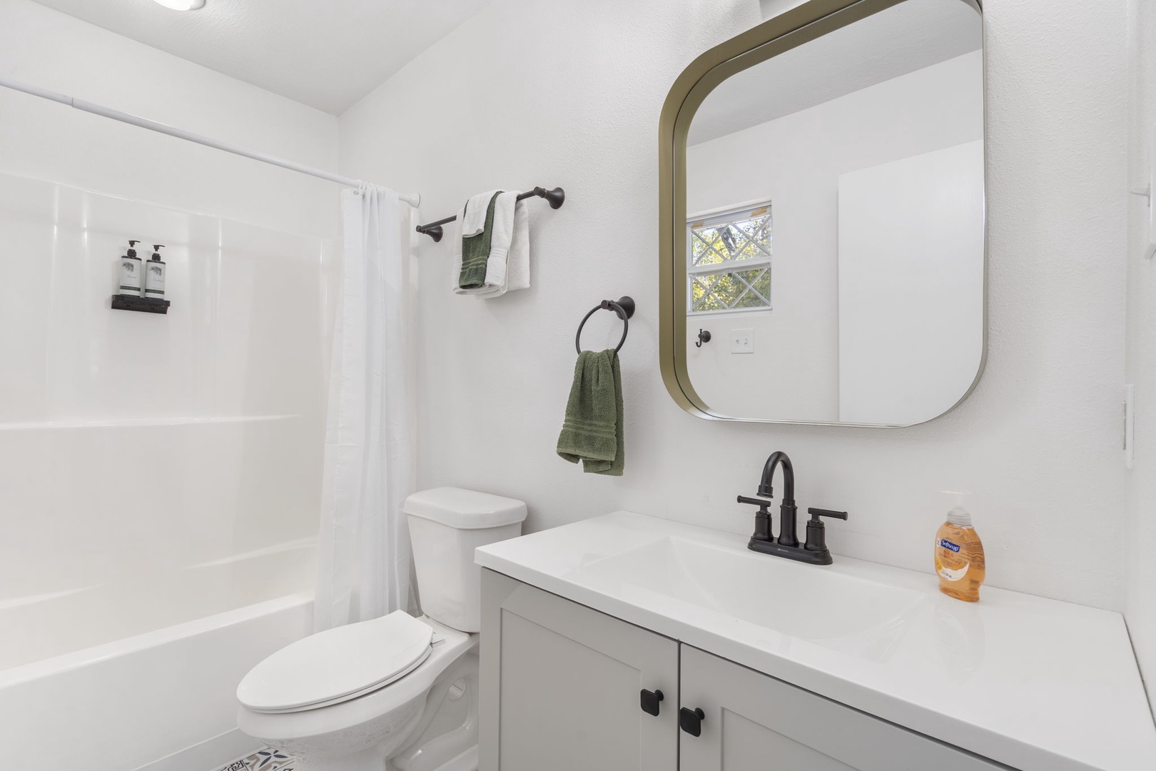 The king en suite bathroom includes a single vanity & shower/tub combo