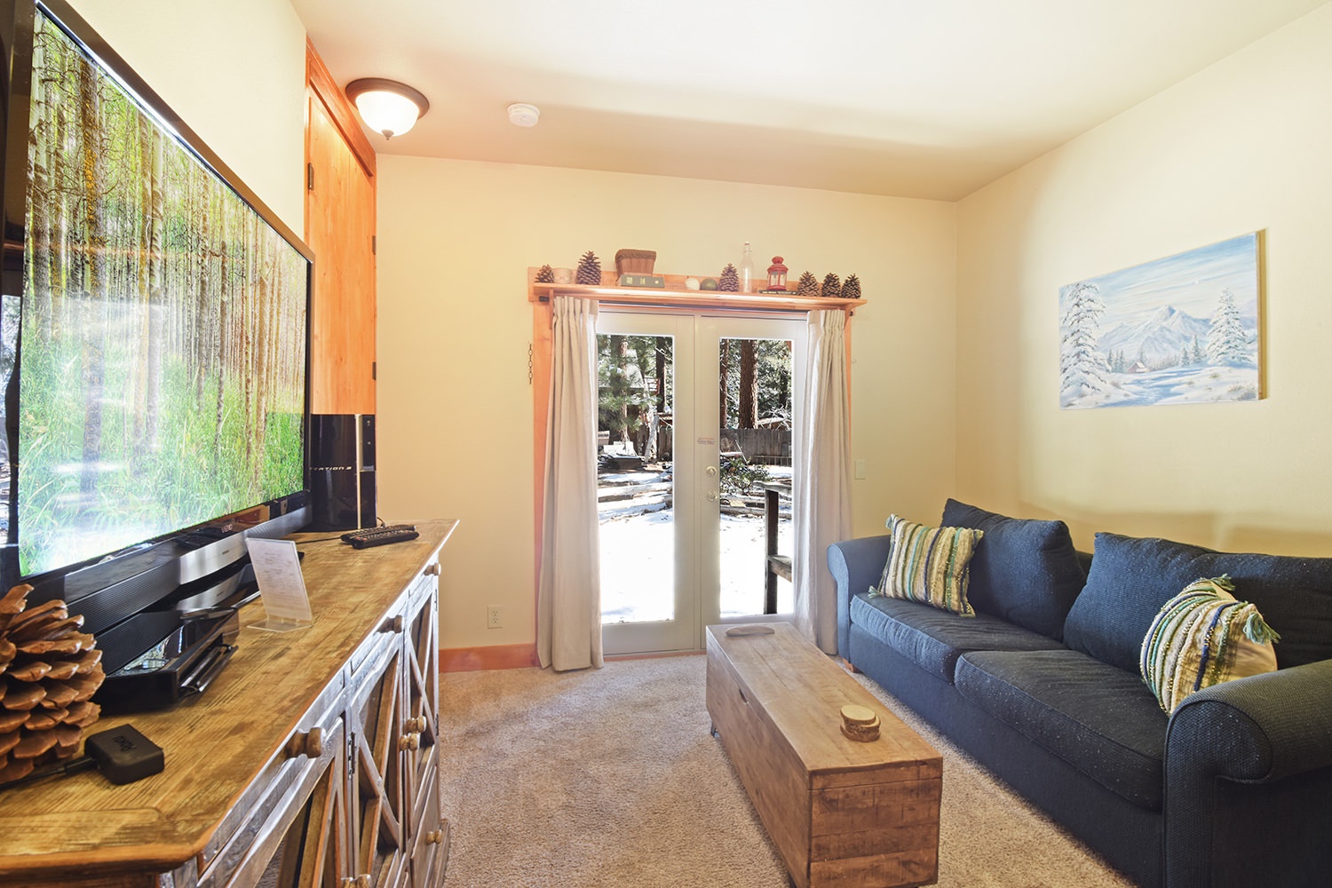 Downstairs living area with sofa sleeper, foosball, and laundry area