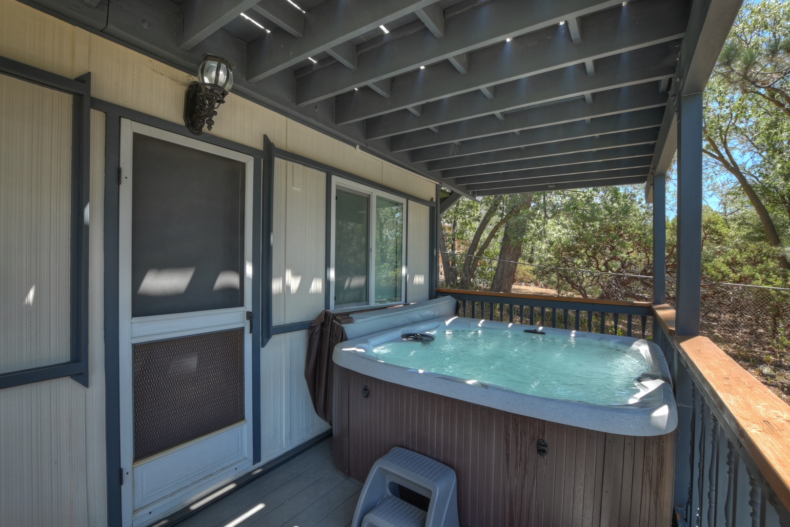 Deck with hot tub, seating, and hammock