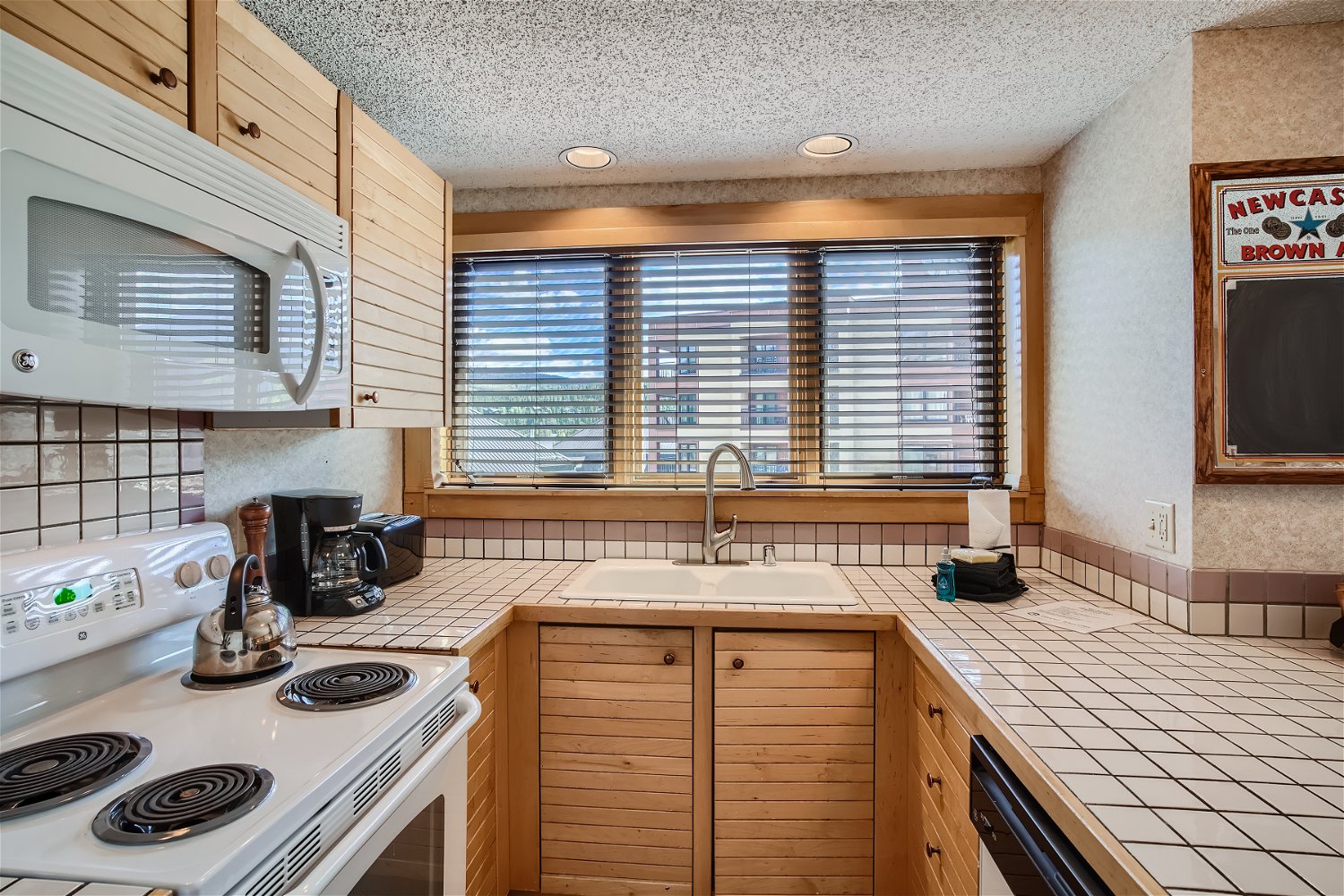 Full kitchen with toaster over, standard drip coffee maker, kettle, and more