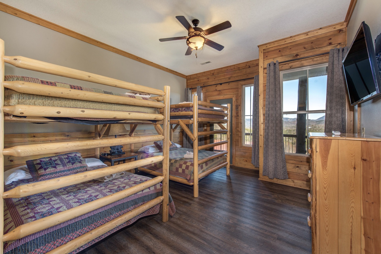 This upper-level balcony suite offers a pair of full bunkbeds, ensuite, & TV