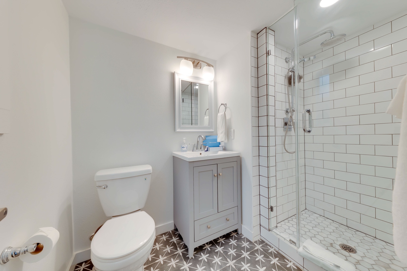 The cozy queen bedroom en suite offers privacy & sleek glass shower