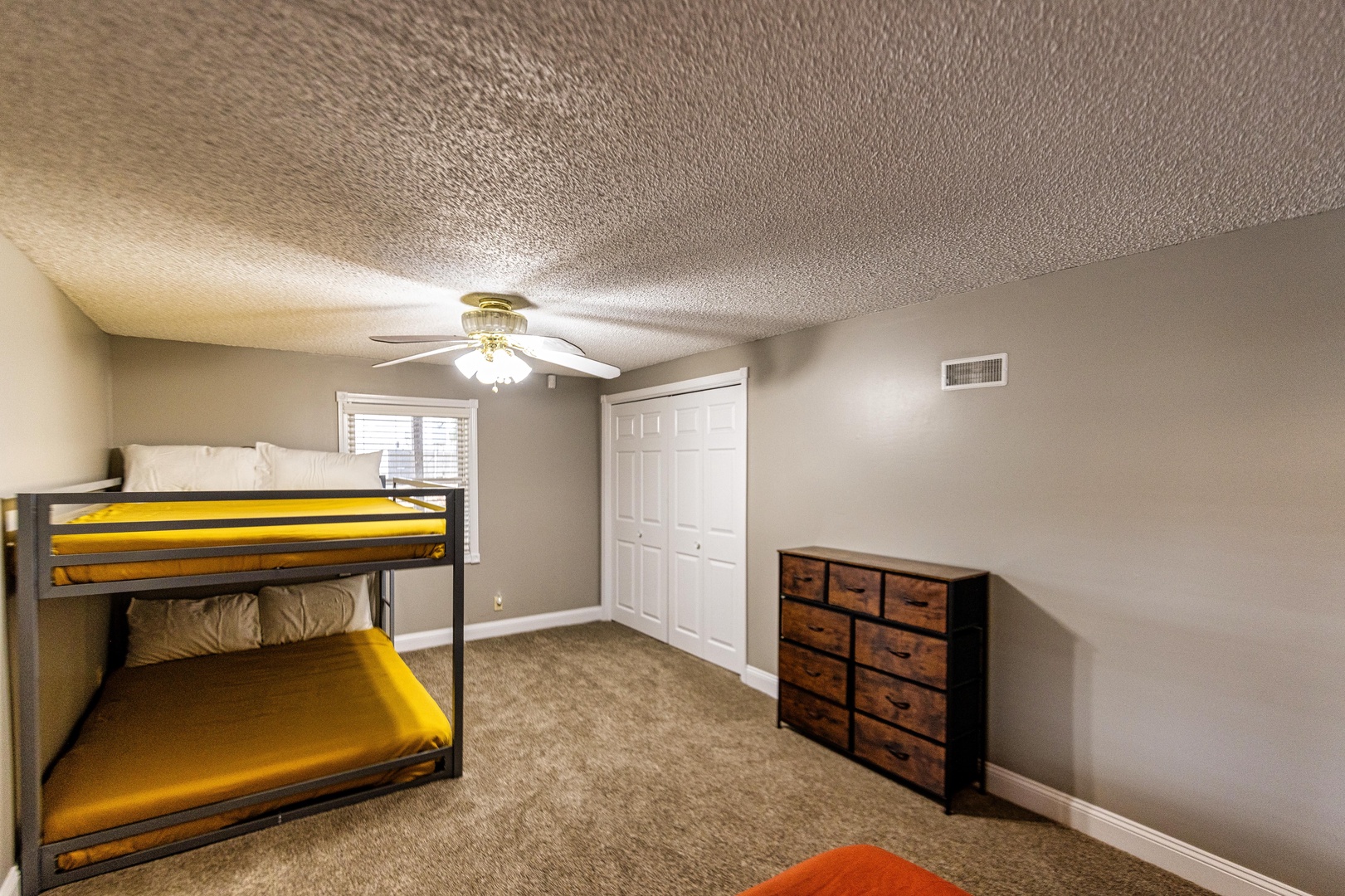 The 2nd lower-level bedroom offers a queen bed & queen-over-queen bunks