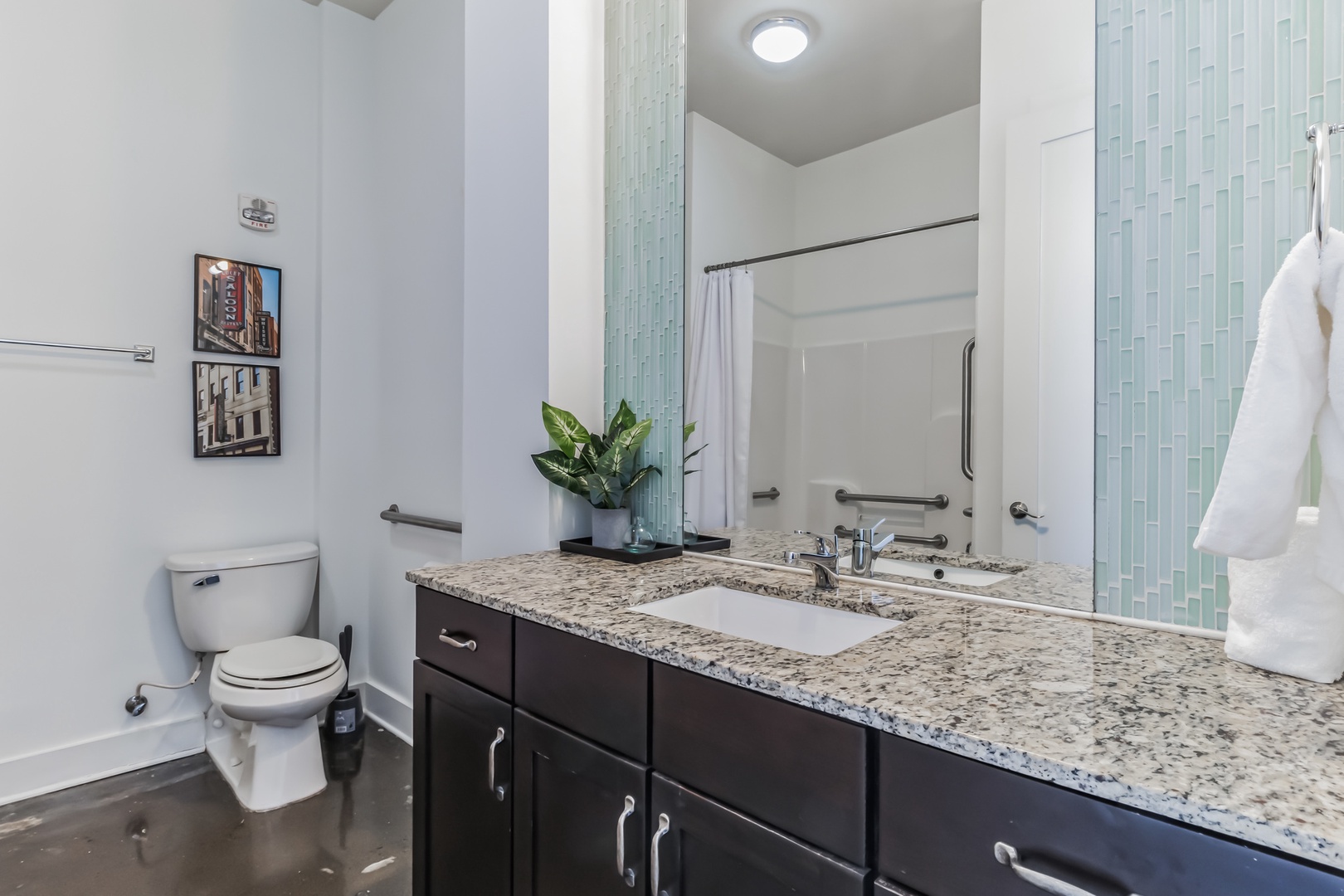 The primary bathroom boasts a spacious vanity and a combined shower/tub