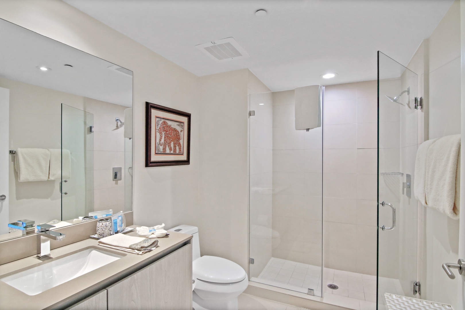 A third full bathroom includes a spacious single vanity & spa-like glass shower