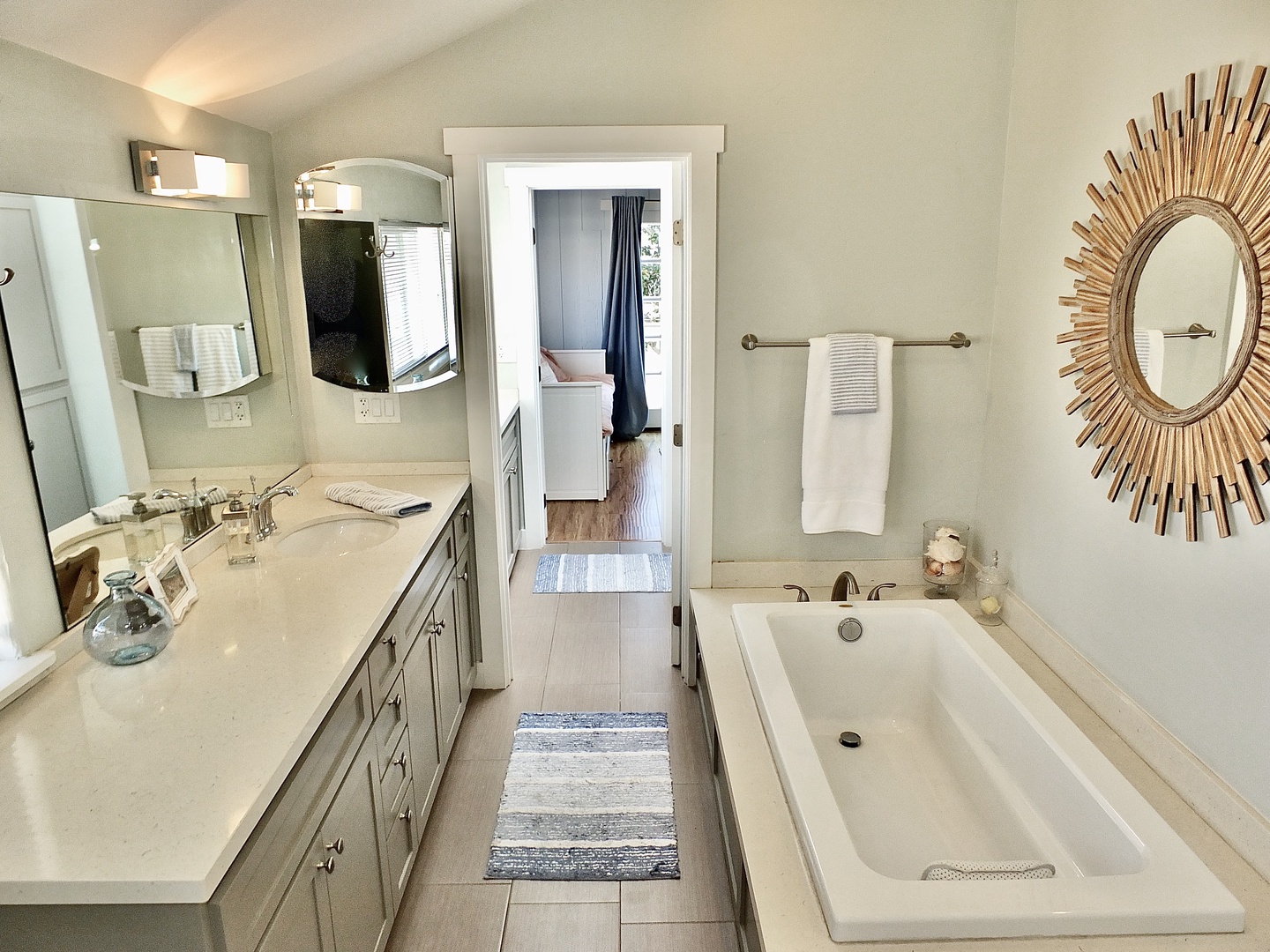 Dual vanities, a glass shower, & luxe soaking tub await in this full bath