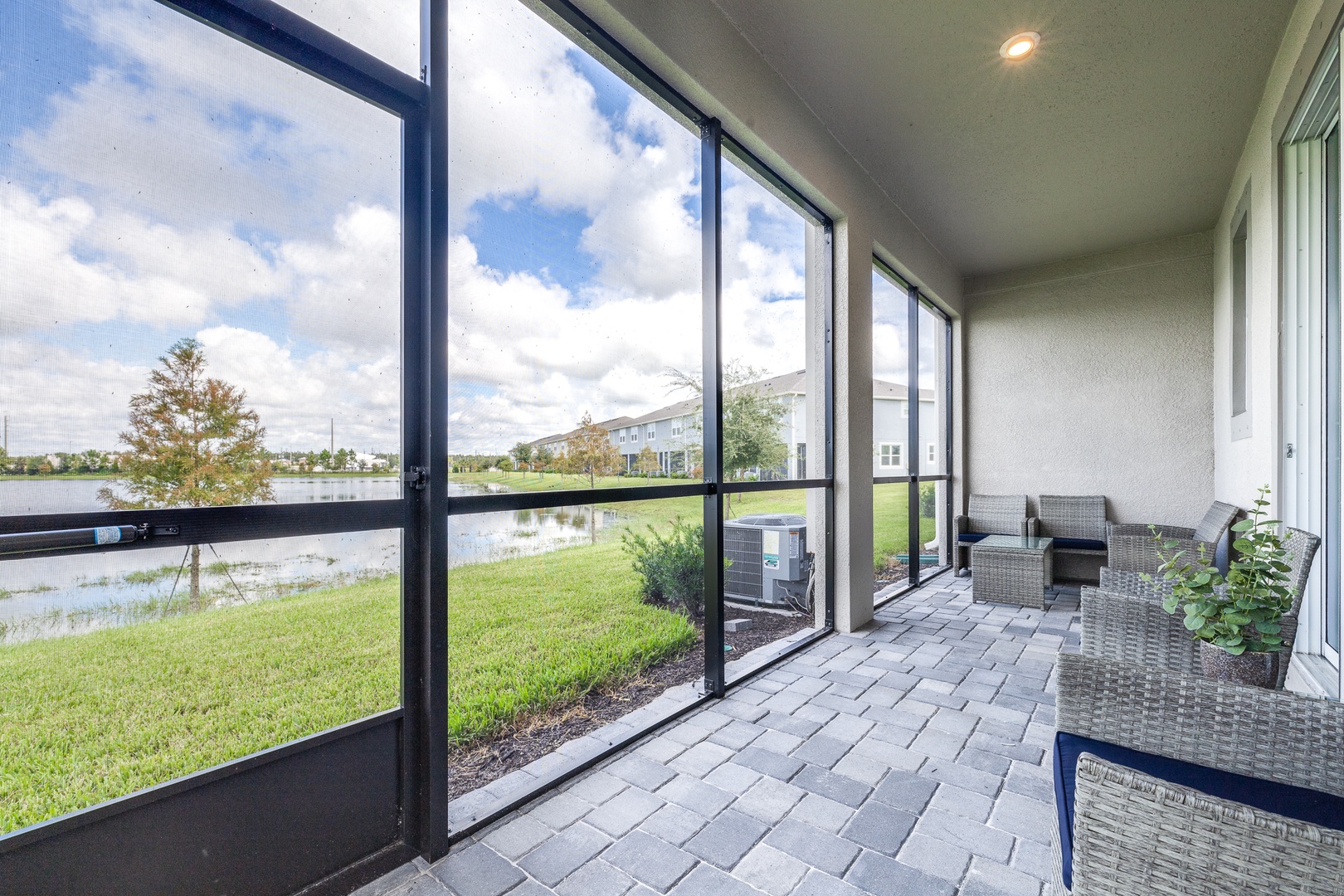 Relax with a drink on the covered back patio while enjoying the waterfront view