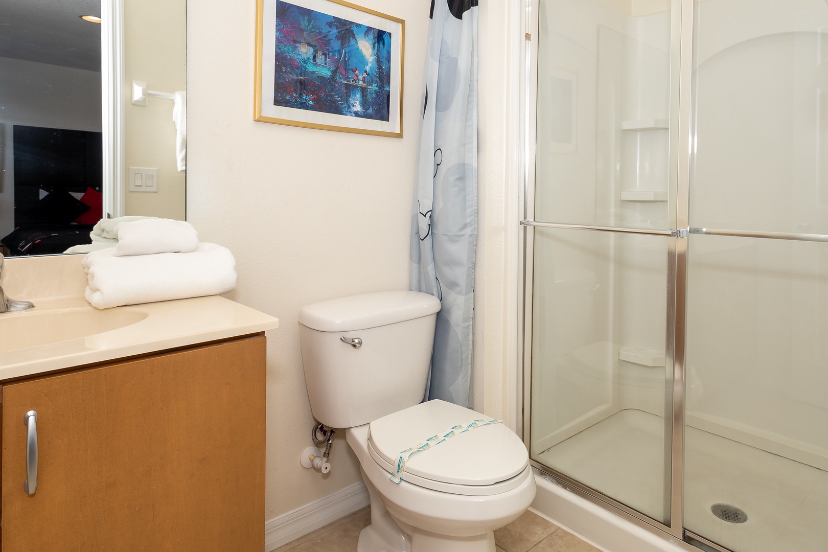 The king en suite offers a single vanity & glass-enclosed shower