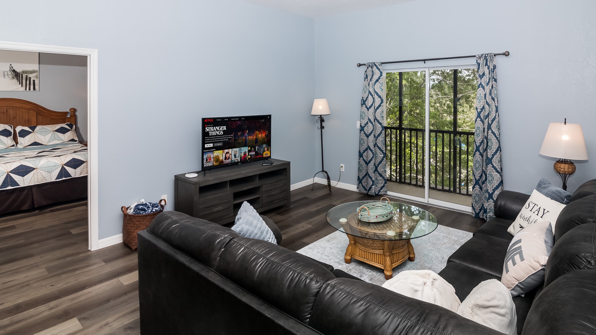 Open living space with Smart TV, board games, and screened balcony access