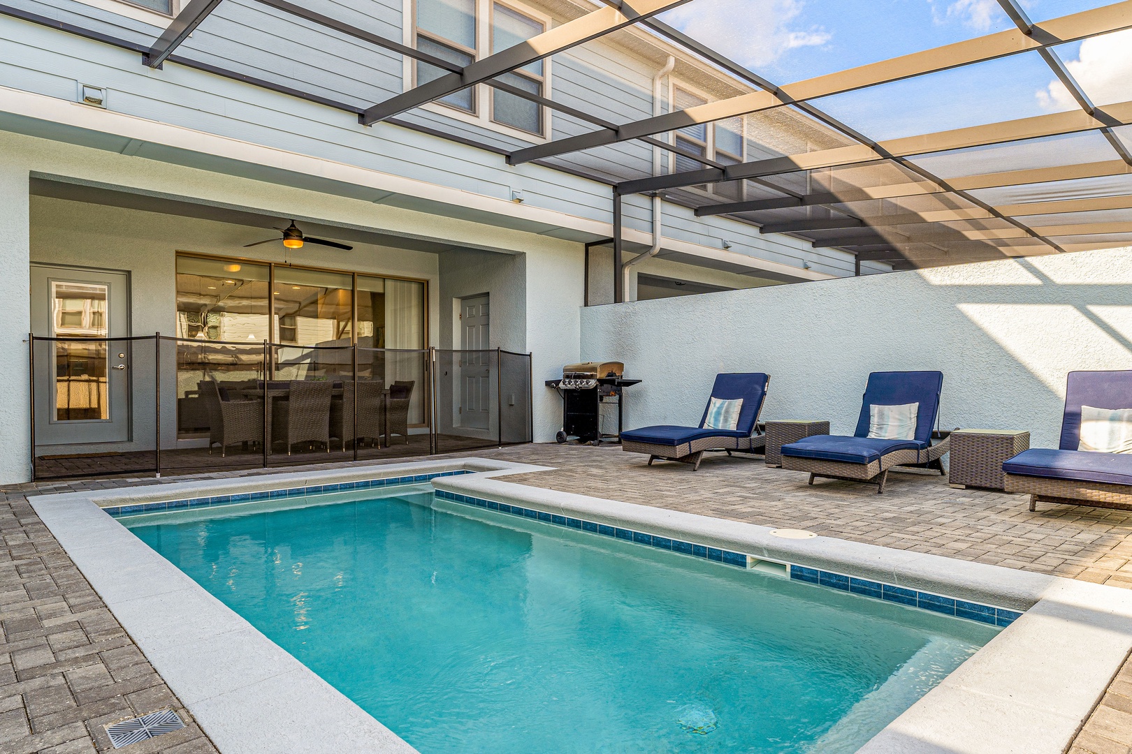 Poolside retreat under the lanai, complete with inviting lounge chairs