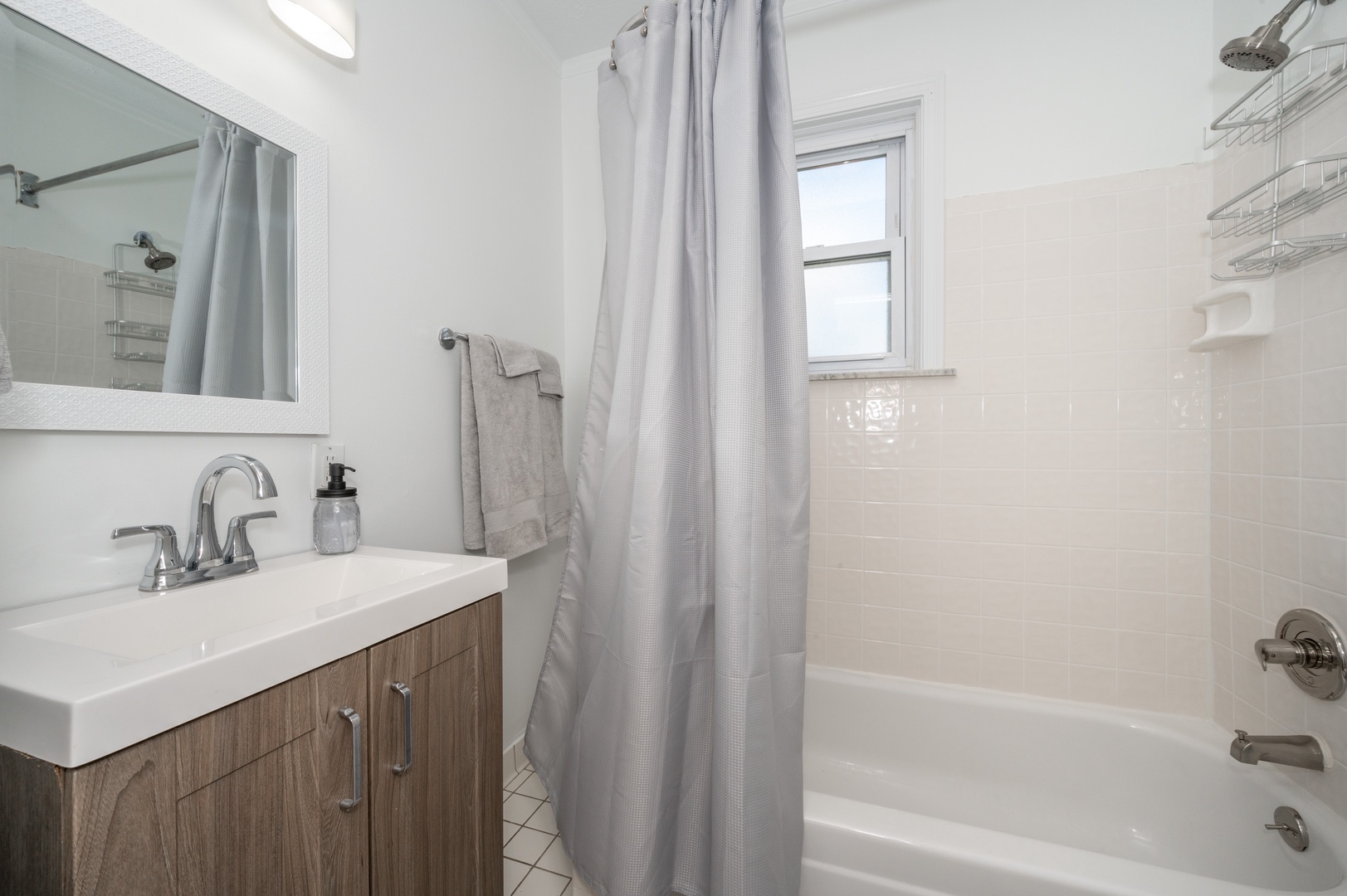 Unit 2 – The main-level full bath offers a single vanity & shower/tub combo