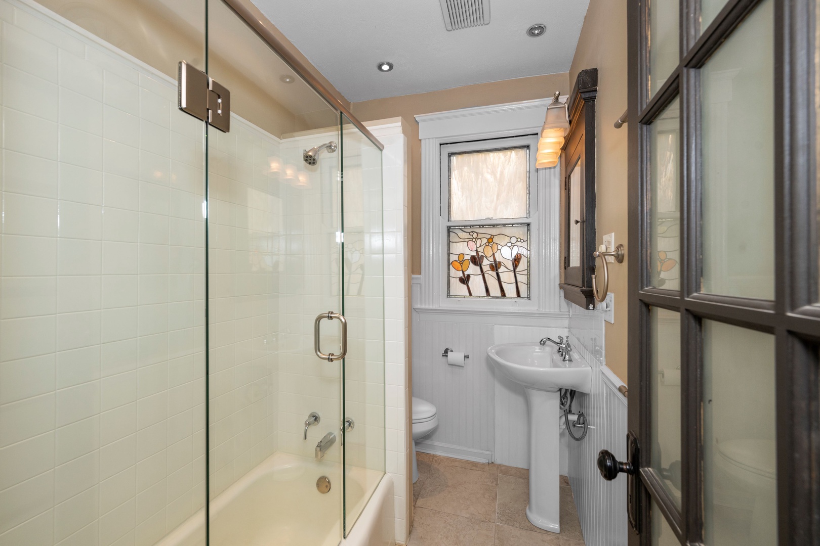 The second-level full bathroom includes a pedestal sink & shower/tub combo