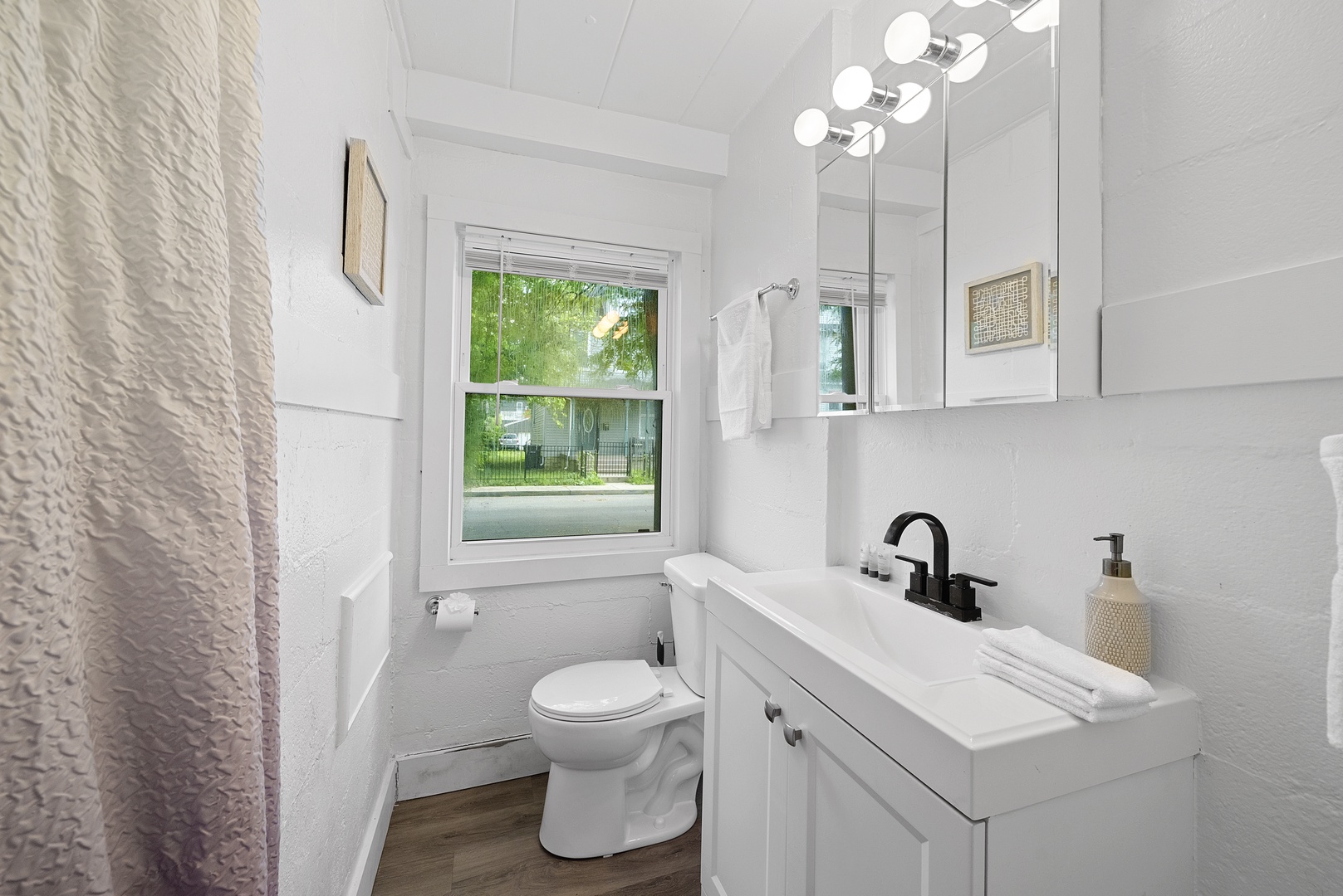 A chic single vanity & shower await in the full bathroom