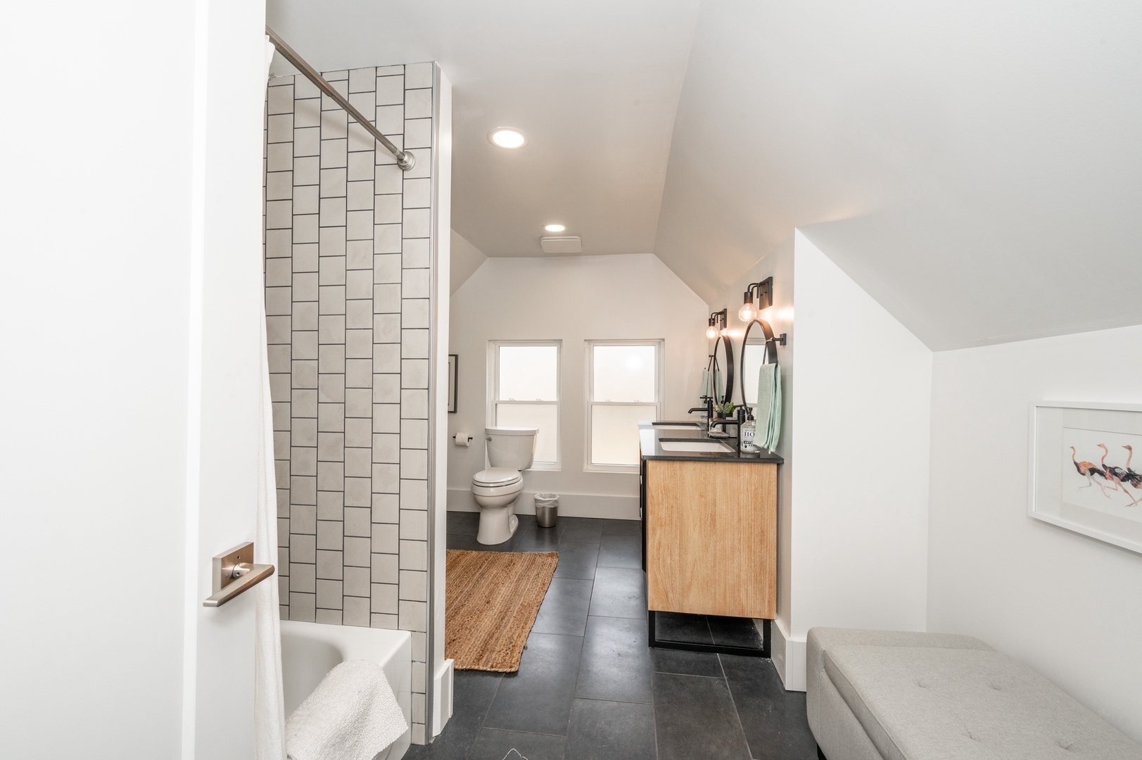 The 3rd-floor full bath showcases a double vanity & shower/tub combo