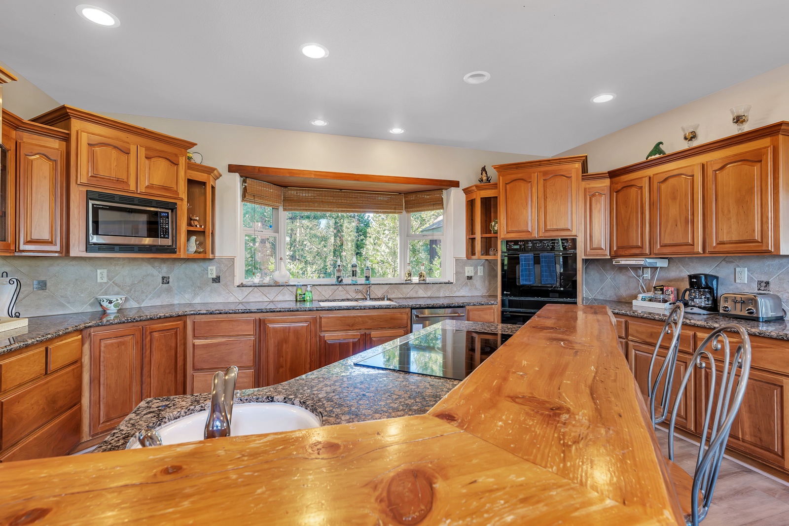 The beautiful kitchen offers ample space & all the comforts of home
