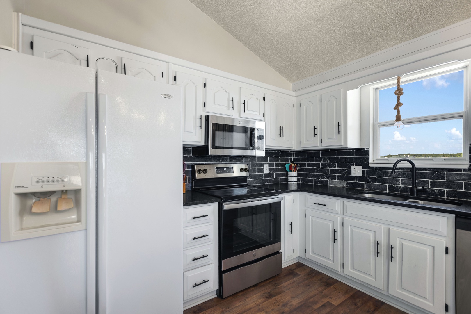 The open, airy kitchen offers ample space & all the comforts of home