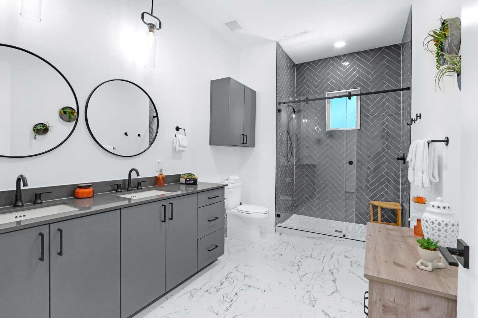 Private dual vanity areas & a glass walk-in shower