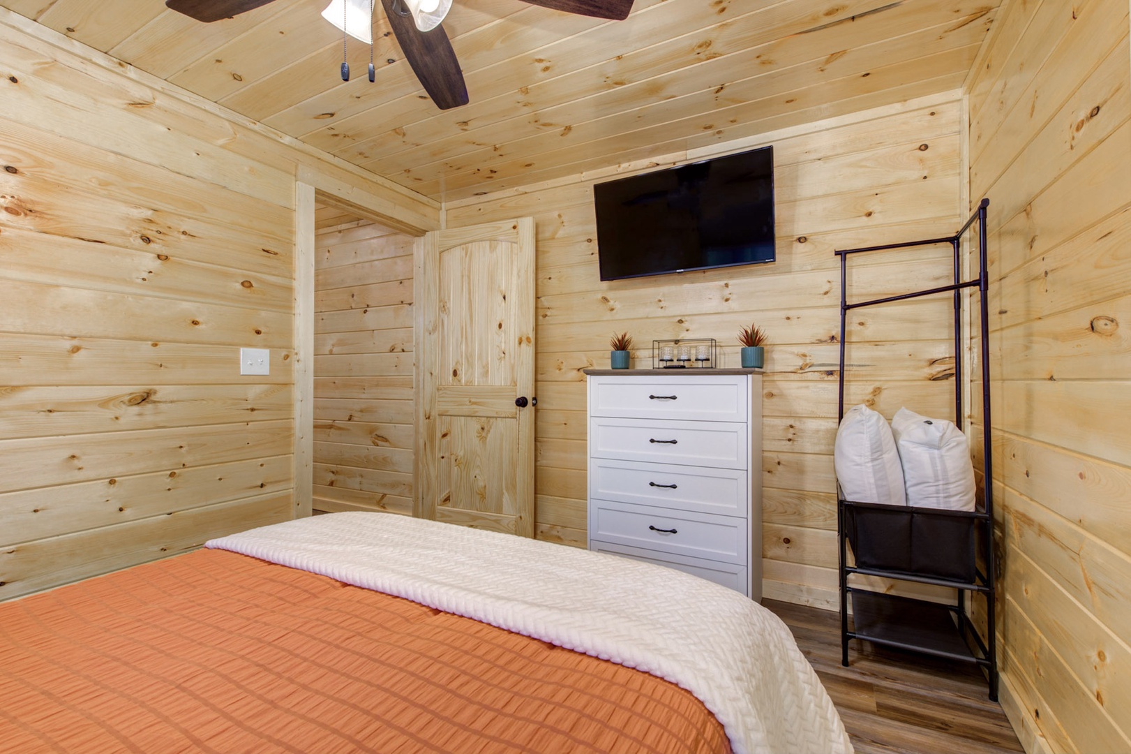 The first bedroom retreat offers a plush queen-sized bed & TV