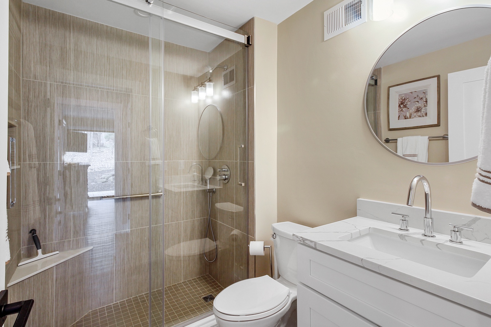 This full shared bathroom includes a single vanity & glass shower