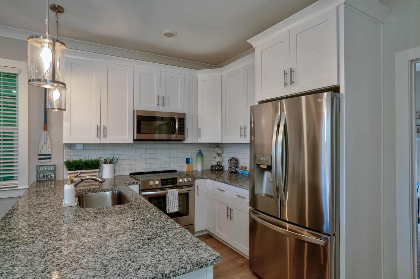 The chic, updated kitchen offers loads of space & all the comforts of home