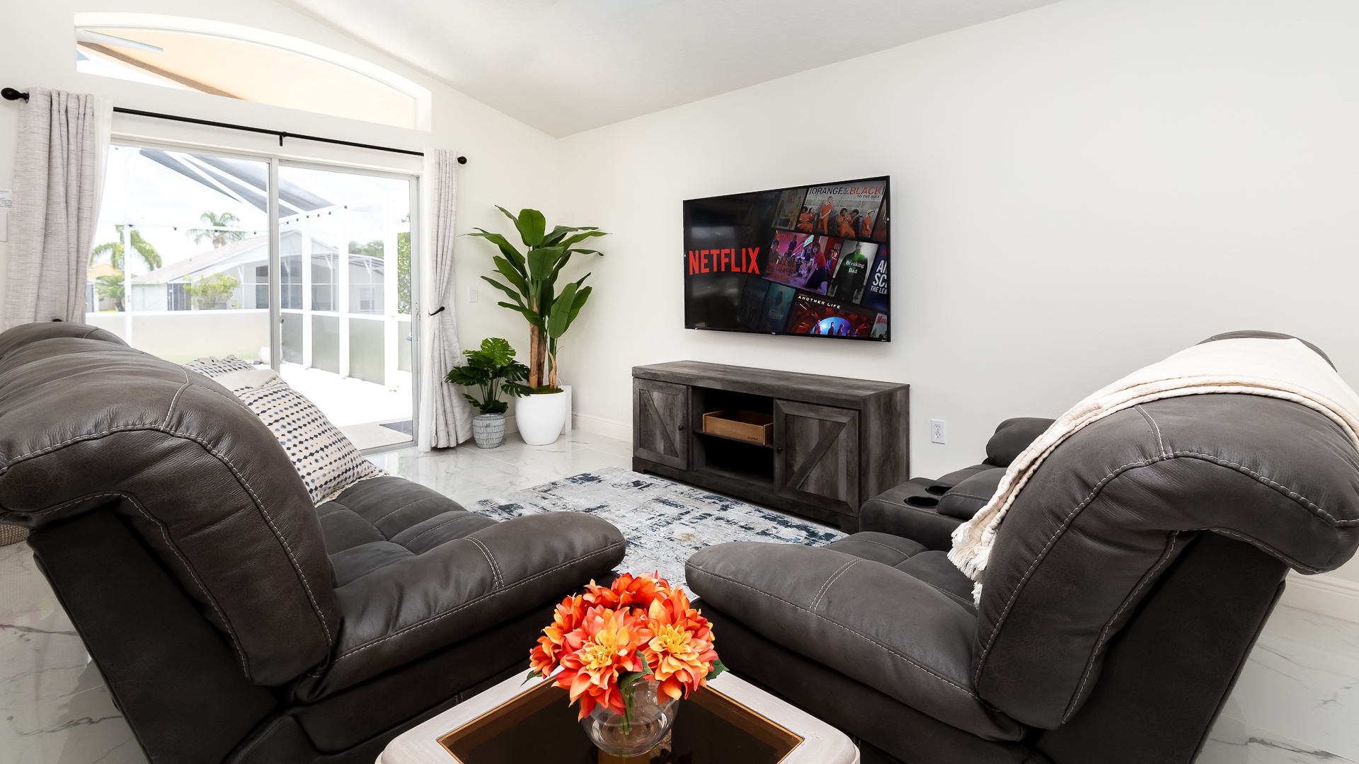 Bright living space with leather seating and Smart TV