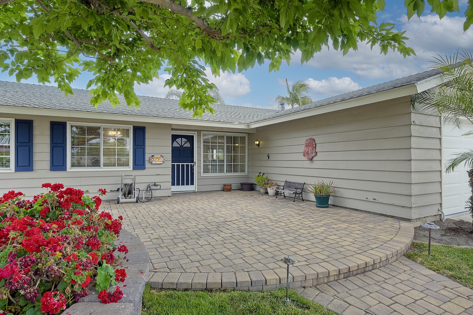 Charming front patio with vibrant flowers, perfect for relaxing and welcoming guests