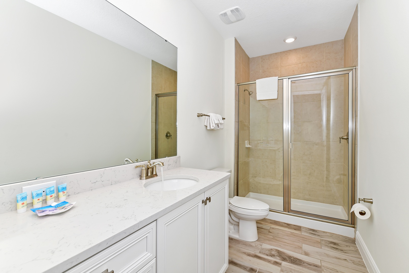Master ensuite bath with double vanity and walk-in shower with glass doors