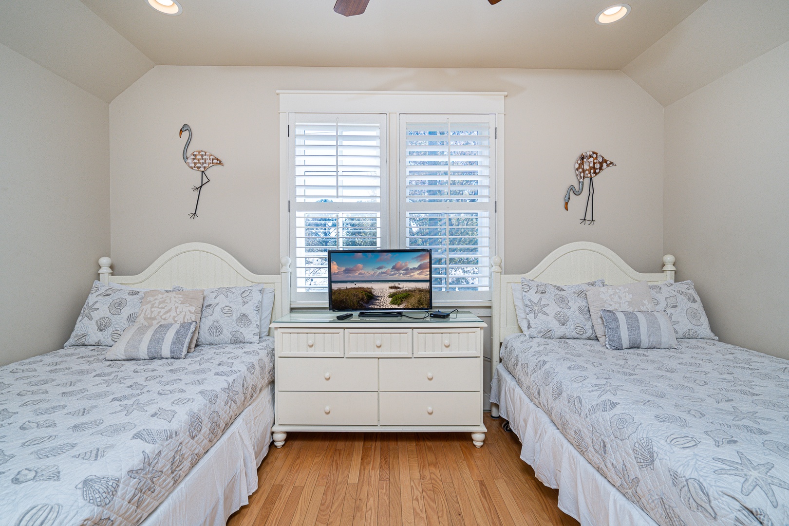 This 2nd-floor bedroom features 2 full beds, 1 twin bed, & a private ensuite.