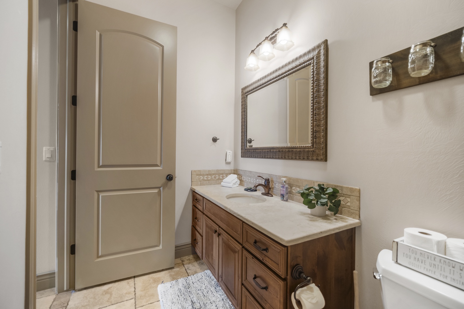 The hall bath features a large single vanity & shower/tub combo