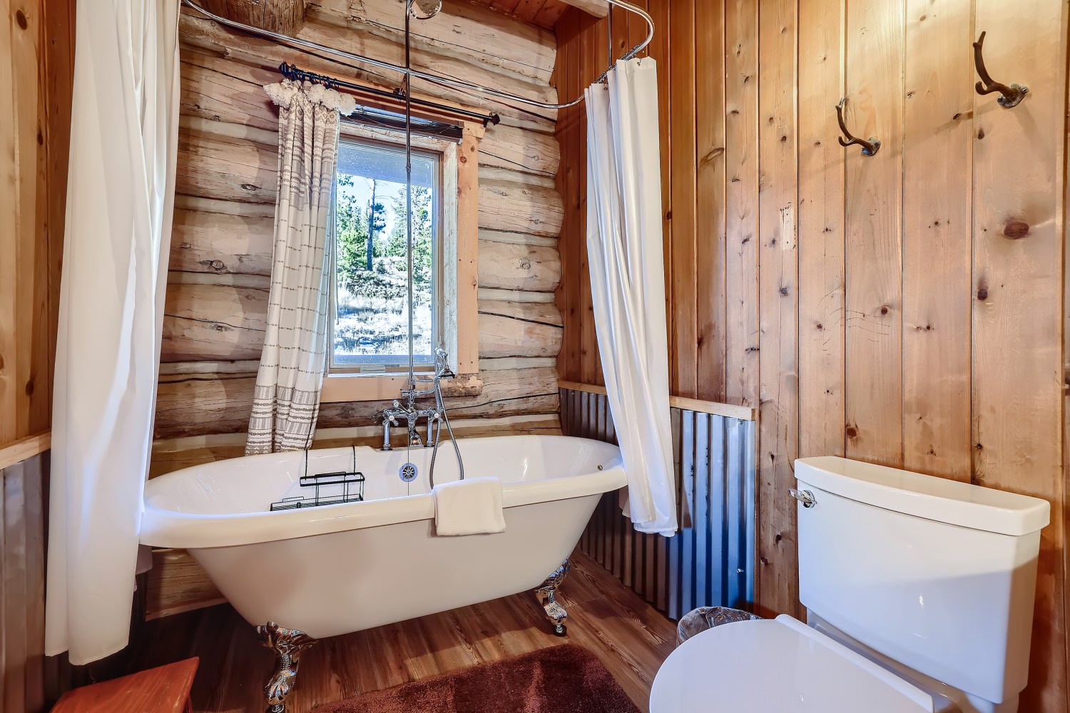 Shared bathroom on the main floor with claw foot tub, and shower combo