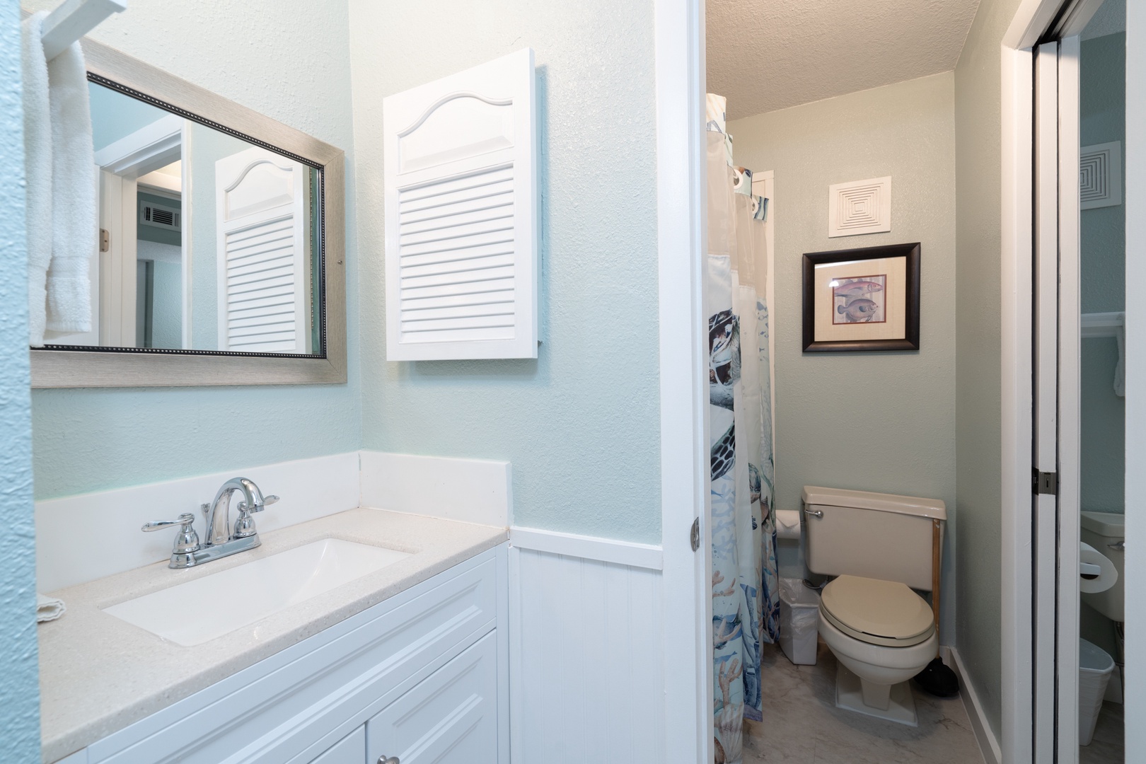 The home’s full bath features a single vanity & shower/tub combo