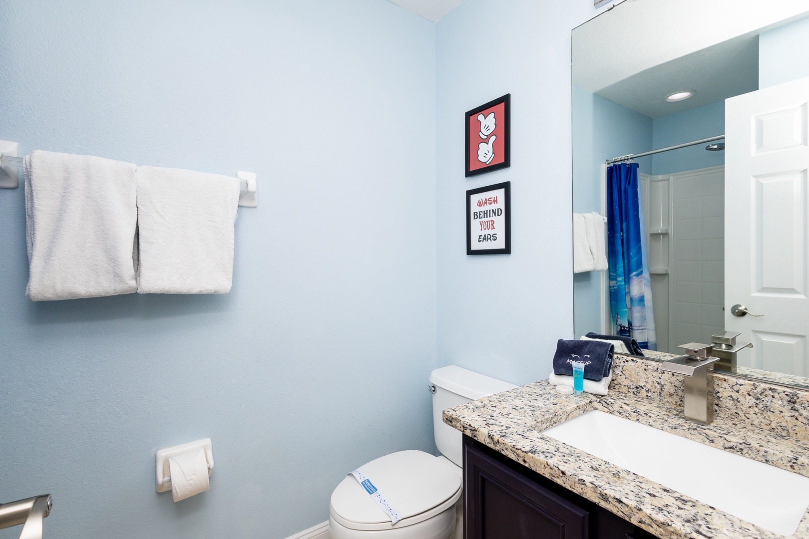 This main-level full bath offers a single vanity & shower/tub combo