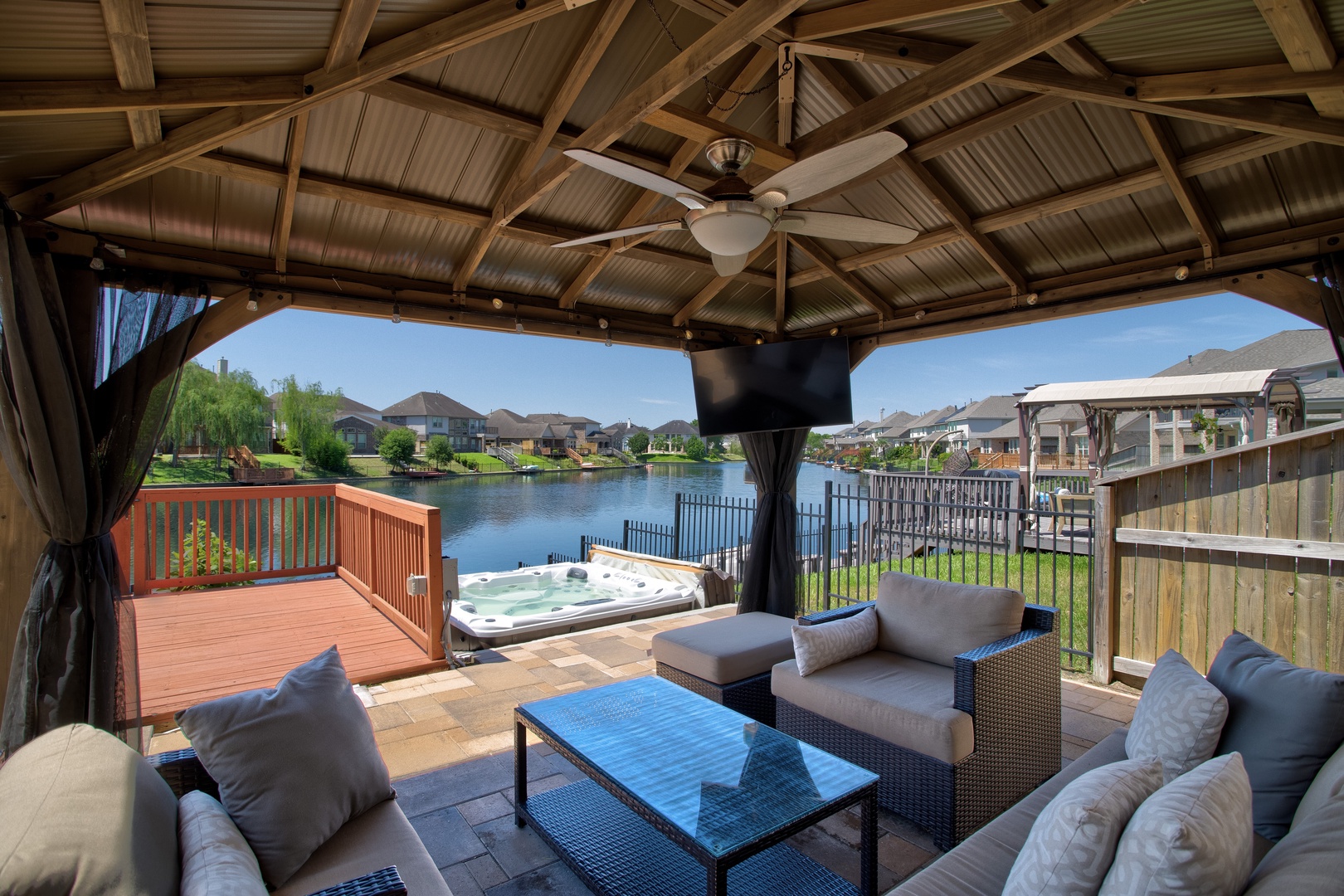 Unwind and enjoy serene lakeside views with your private dock, comfortable seating, and relaxing hot tub