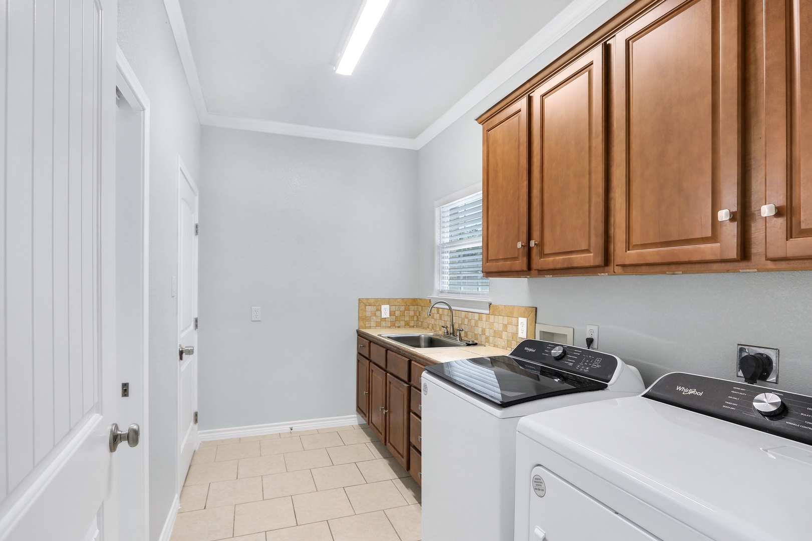 Private laundry is available for your stay, tucked away next to the garage