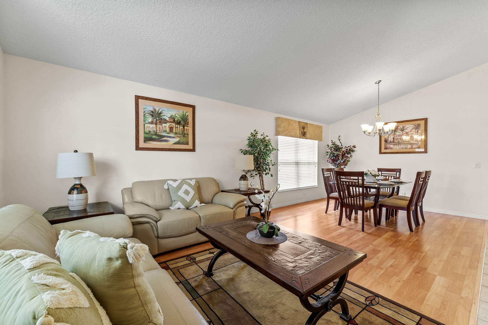 Front living room with a full-size sleeper sofa and dining area for 6