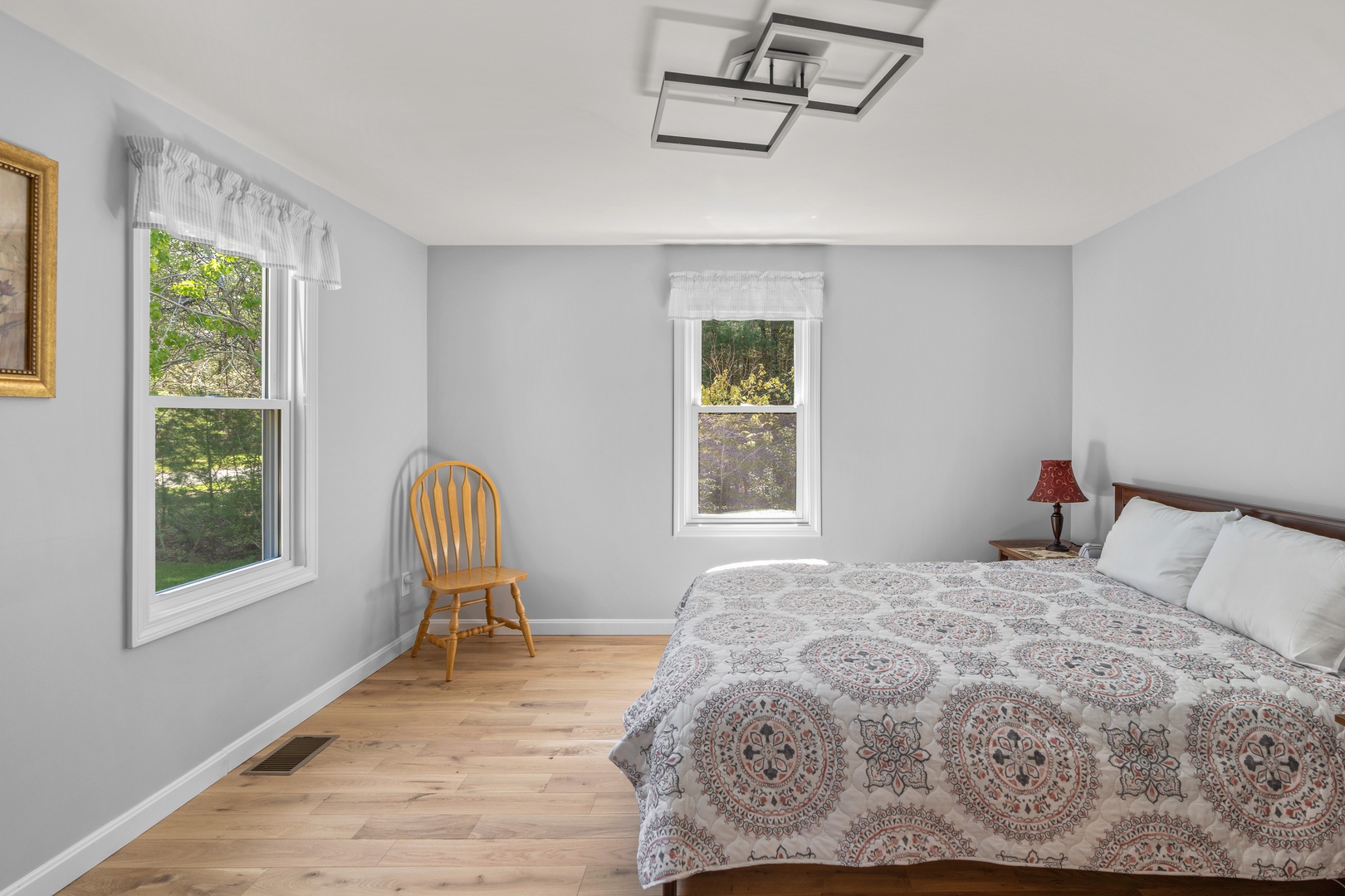 This serene main-floor bedroom features a cozy queen-sized bed