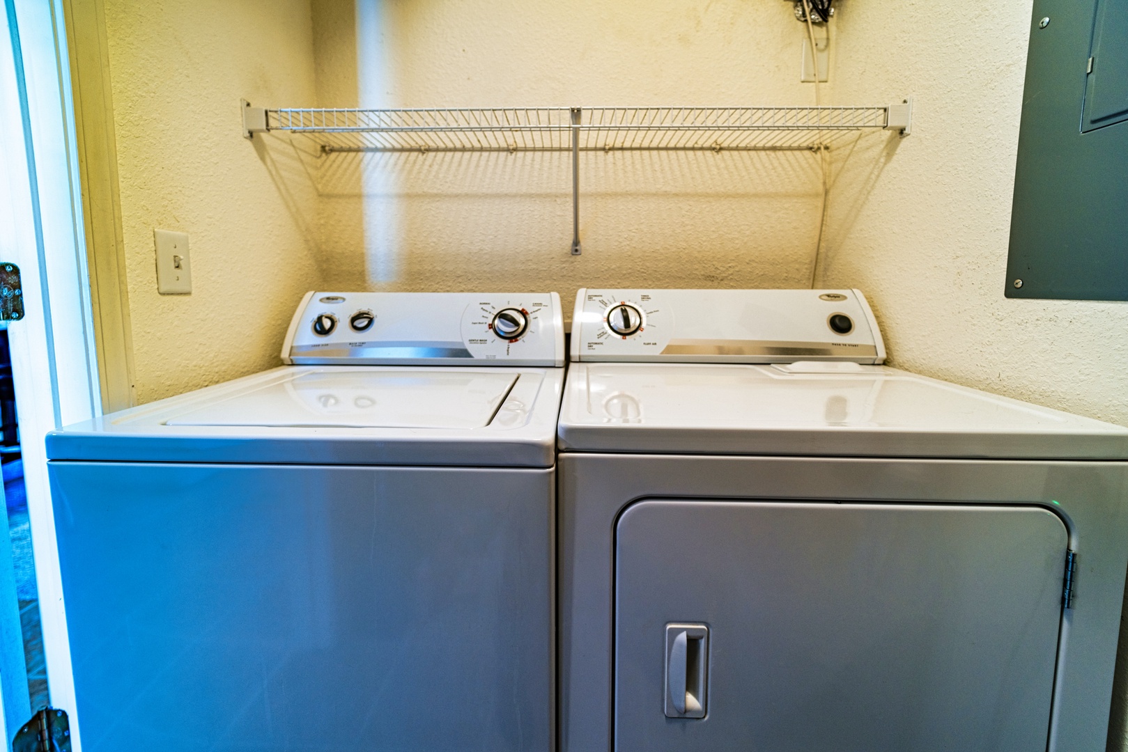 Private laundry facilities are tucked away within the utility closet