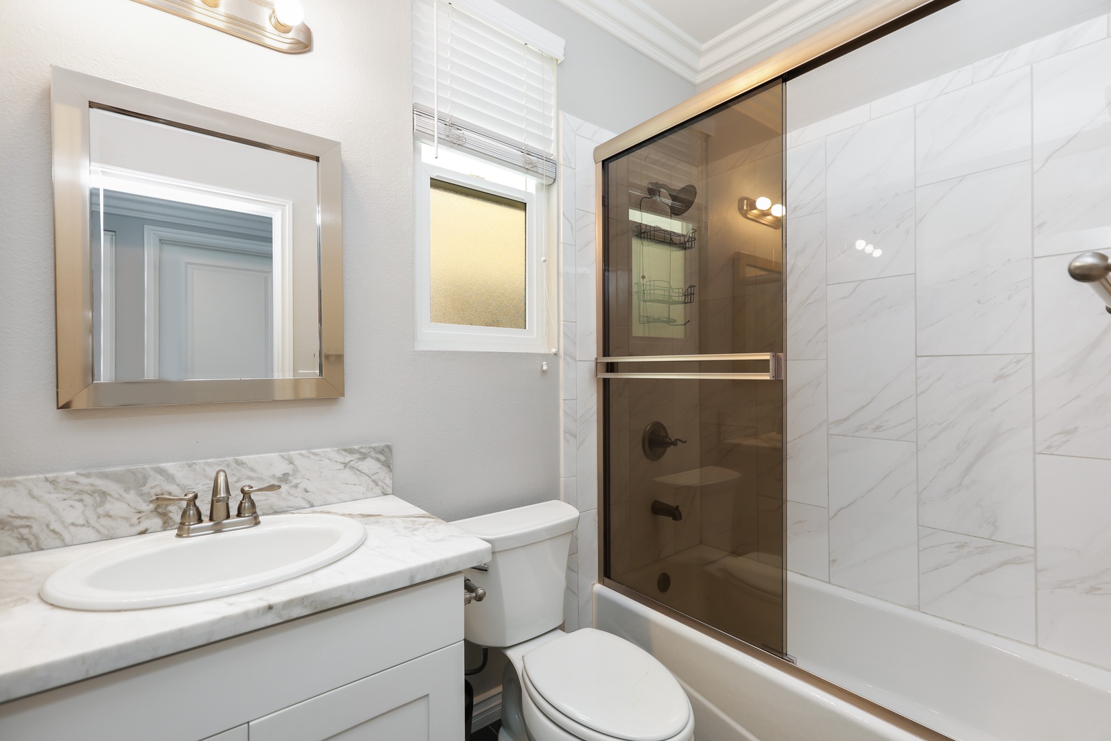 Wash up in the king ensuite, featuring a single vanity & shower/tub combo