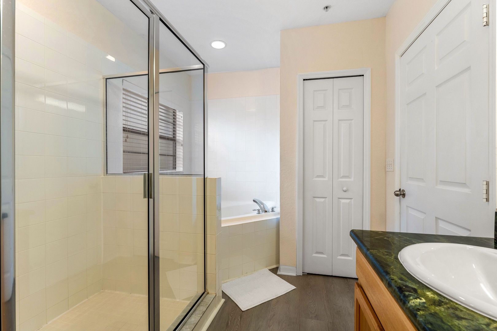 Wash up in this ensuite, featuring a single vanity with walk-in shower